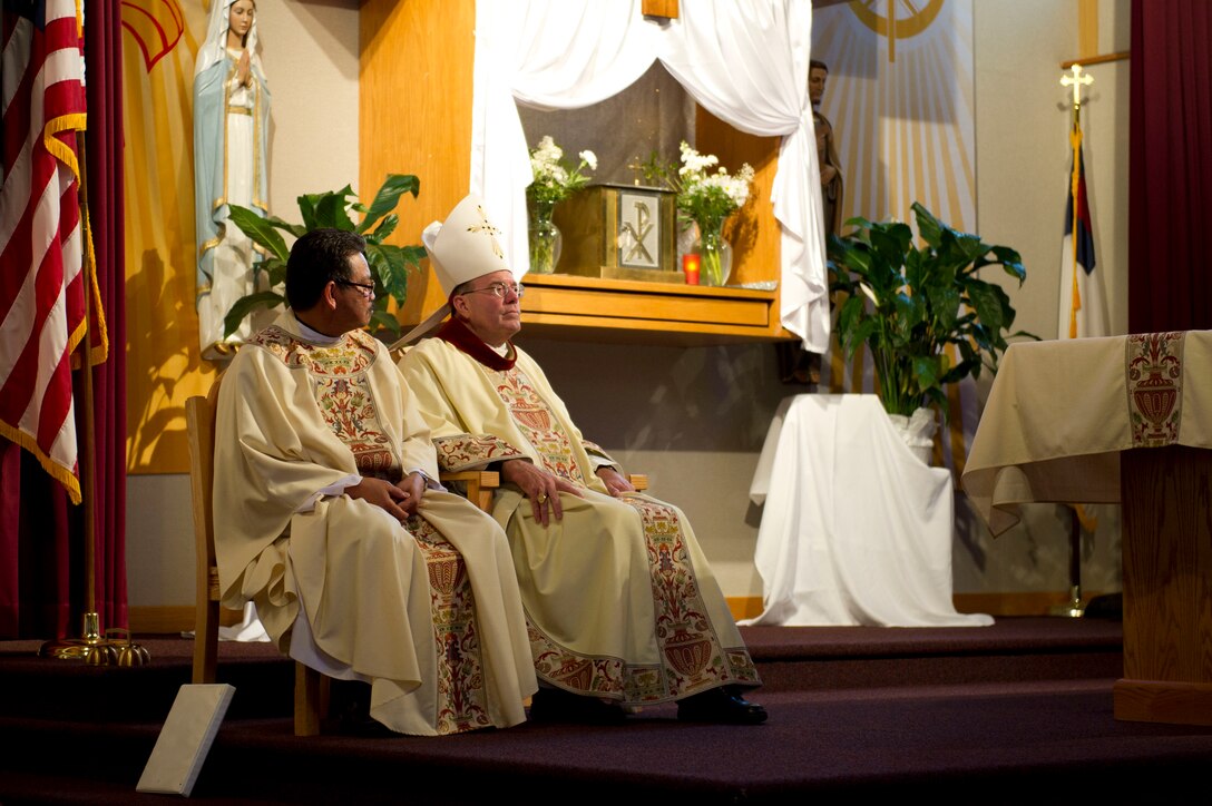 Father Juan Salonga, 92nd Air Refueling Catholic Priest, listens to Most Reverend Neal J. Buckon, Auxiliary Bishop of the Archdiocese for the Military Services, during a religious service May 4, 2016, at Fairchild Air Force Base, Wash. Buckon visited with Airmen from the 92nd Aircraft Maintenance Squadron and also met with 92nd and 141st Air Refueling Wing leaders. (U.S. Air Force photo/Airman 1st Class Nick J. Daniello) 