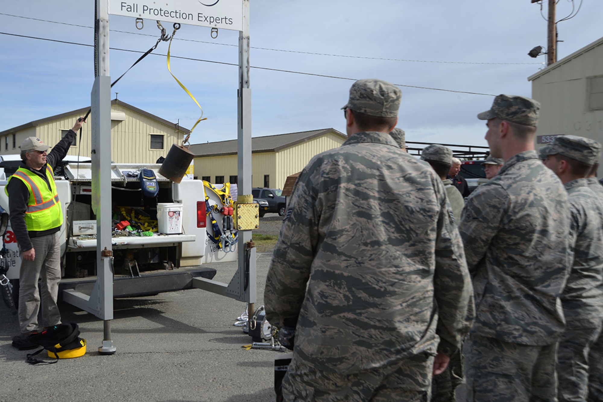 Trace Savage, a fall protection manufacturer representative with 3M, drops a weight as part of a simulated fall protection scenario at the civil engineer compound on Joint Base Elmendorf-Richardson, Alaska, May 4, 2016. Fall Protection Awareness Week is May 2 to 13. (U.S. Air Force photo by Airman 1st Class Javier Alvarez)