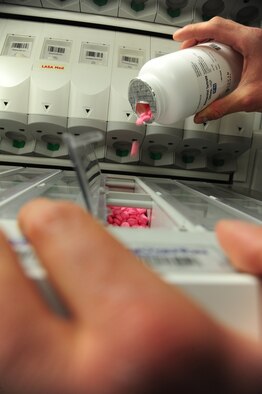U.S. Air Force Senior Airman Marco Cardenas, a 509th Medical Support Squadron pharmacy technician, replenishes an automated counting machine at Whiteman Air Force Base, Mo., April 20, 2016. The automated counting machine is designed to ensure an accurate amount of medication is distributed for each prescription before being issued to the patient.  (U.S. Air Force photo by Airman 1st Class Keenan Berry) 