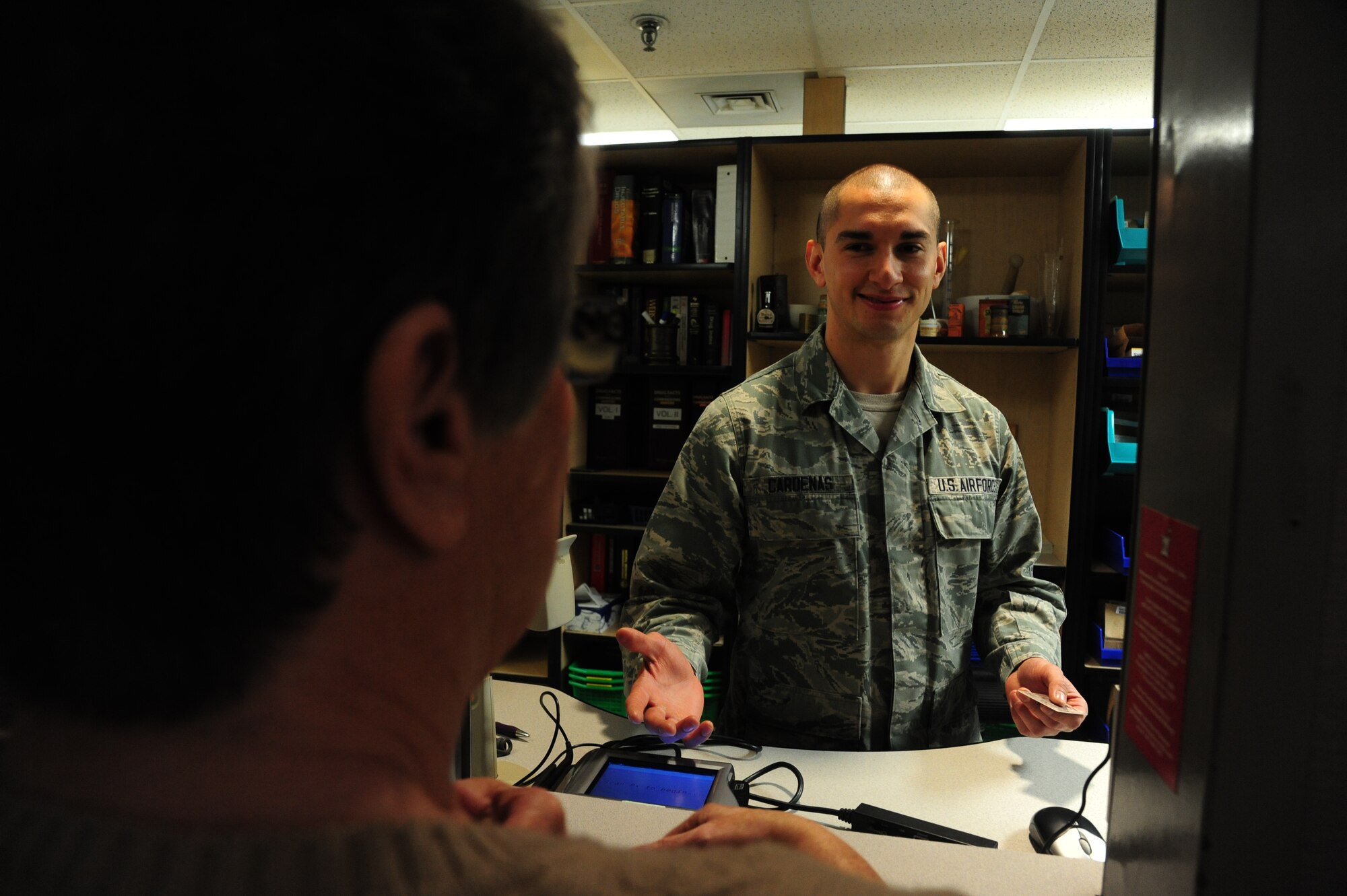 U.S. Air Force Senior Airman Marco Cardenas, a 509th Medical Support Squadron pharmacy technician, counsels a patient at Whiteman Air Force Base, Mo., April 20, 2016, on the proper use of medications. Pharmacy technicians must inform patients on the purpose of their medications, how to take them properly and what other types of medications can be used in conjunction with them. (U.S. Air Force photo by Airman 1st Class Keenan Berry)
