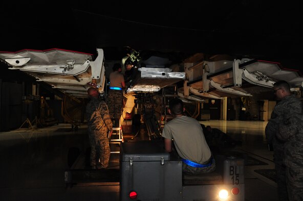 U.S. Air Force load crew members from the 393rd Aircraft Maintenance Unit, load an AGM-158 Joint Air-to-Surface Standoff Missile into a B-2 Spirit weapons load trainer during a weapons load competition at Whiteman Air Force Base, Mo., April 27, 2016. The team chief of the load crew oversees loading operations to ensure teamwork is as smooth as possible. (U.S. Air Force photo by Airman 1st Class Keenan Berry) 