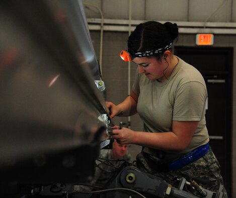 U.S. Air Force Airman 1st Class Cierra Hall, 393rd Aircraft Maintenance Unit load crew member, positions an AGM-158 loading adapter during a weapons load competition at Whiteman Air Force Base, Mo., April 27, 2016. The competition is designed to showcase the teamwork, precision and attention to detail amongst Airmen who support nuclear deterrence and global strike operations. (U.S. Air Force photo by Airman 1st Class Keenan Berry) 