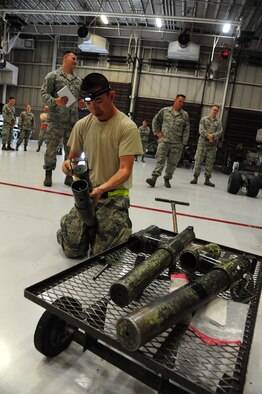 U.S. Air Force Senior Airman Yu Leung, a 393d Aircraft Maintenance Unit (AMU) load crew member, inspects MHU-110 trailer stanchions during a weapons load competition at Whiteman Air Force Base, Mo., April 27, 2016. The 393d AMU load crew team 10 placed first during the competition. (U.S. Air Force photo by Airman 1st Class Keenan Berry)