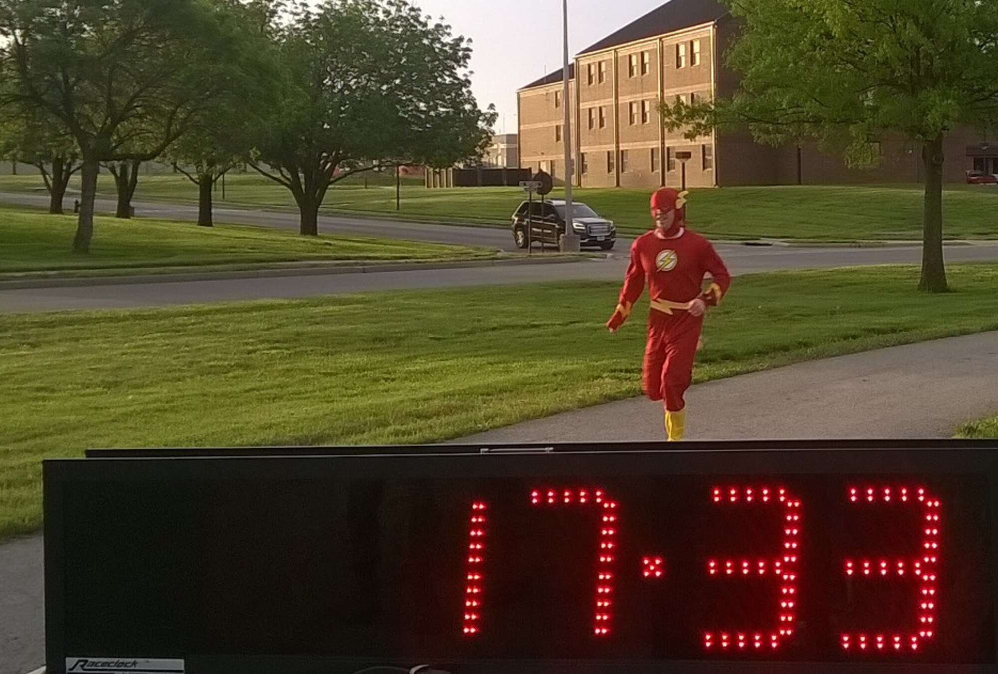 A masked runner crosses the finish line in first place during the 5K Race for Respect at Whiteman Air Force Base, Mo., April 29, 2016. Members of Team Whiteman are encouraged to act like superheroes by choosing to step up, stand up and speak up. (Courtesy photo)