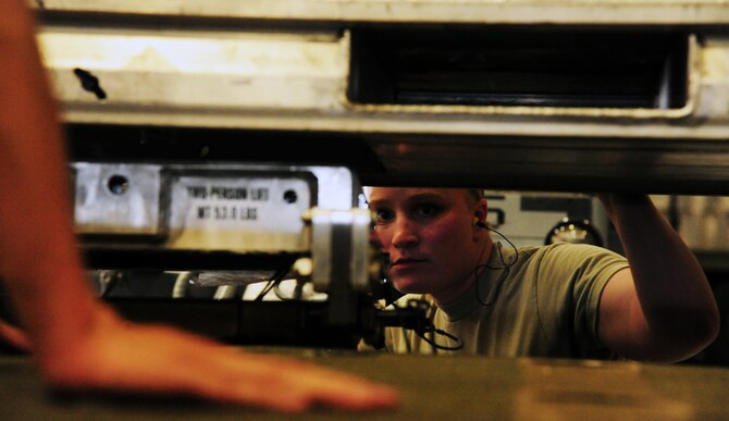 U.S. Air Force Airman 1st Class Victoria Rogers, a 393rd Aircraft Maintenance Unit load crew member, positions an AGM-158 Joint Air-to-Surface Standoff Missile loading adapter during a weapons load competition at Whiteman Air Force Base, Mo., April 27, 2016. Load crew teams must account for munitions safety before preparing weapons for loading. (U.S. Air Force photo by Airman 1st Class Keenan Berry)