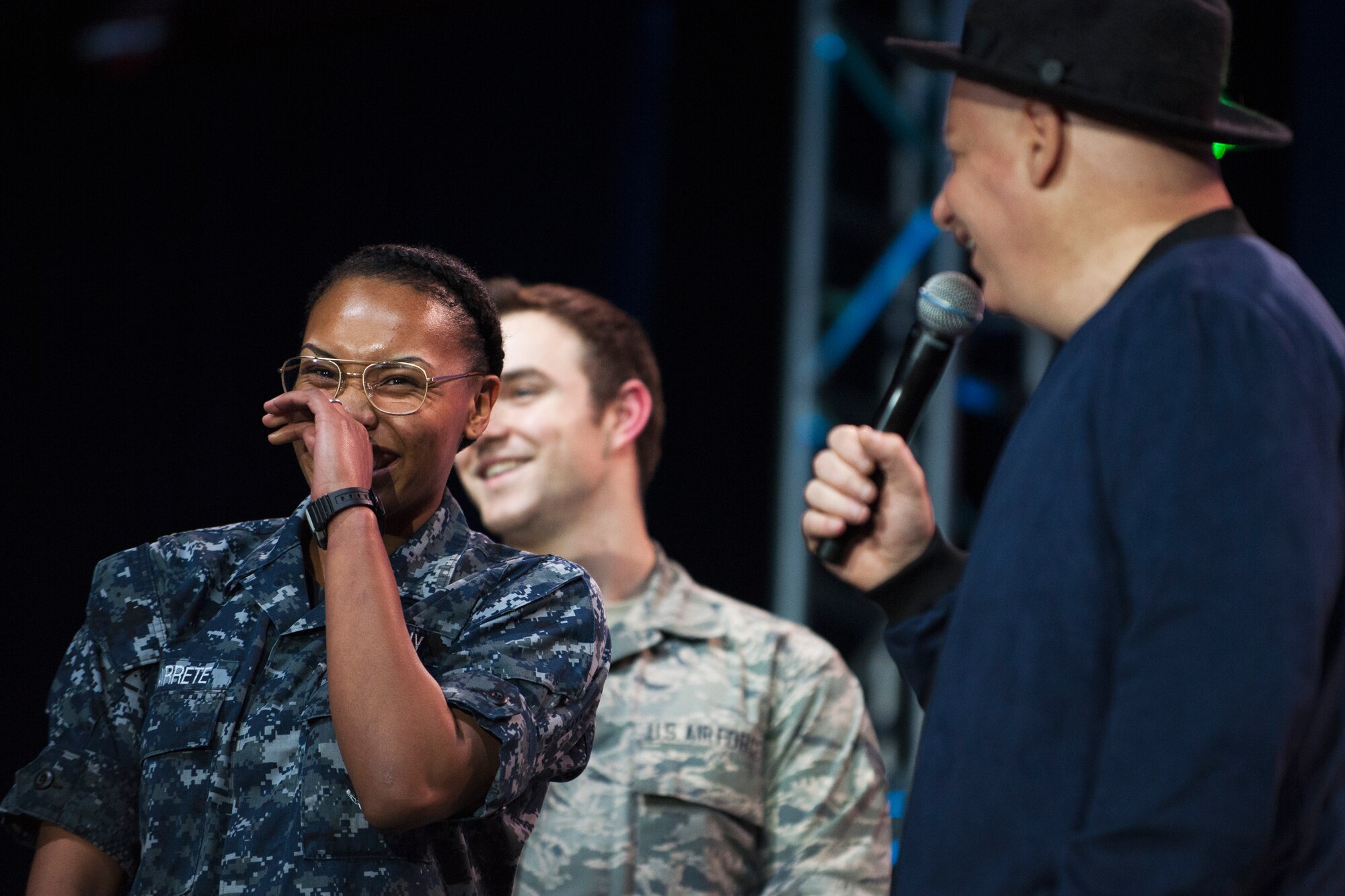 A Sailor laughs while getting ‘roasted’ by Jeff Ross, comedian, during the ‘Celebration of Service’ comedy show on Joint Base Andrews, Md., May 5, 2016. Ross had a dozen random service members come on stage to be ‘roasted’, or joked about. Nearly 1,500 service members, veterans and their families were on hand to see performances by Judd Apatow, Mike Birbiglia, Kristen Schaal, Hasan Minhaj, John Mulaney and Jeff Ross. (U.S. Air Force photo by Airman 1st Class Philip Bryant)
