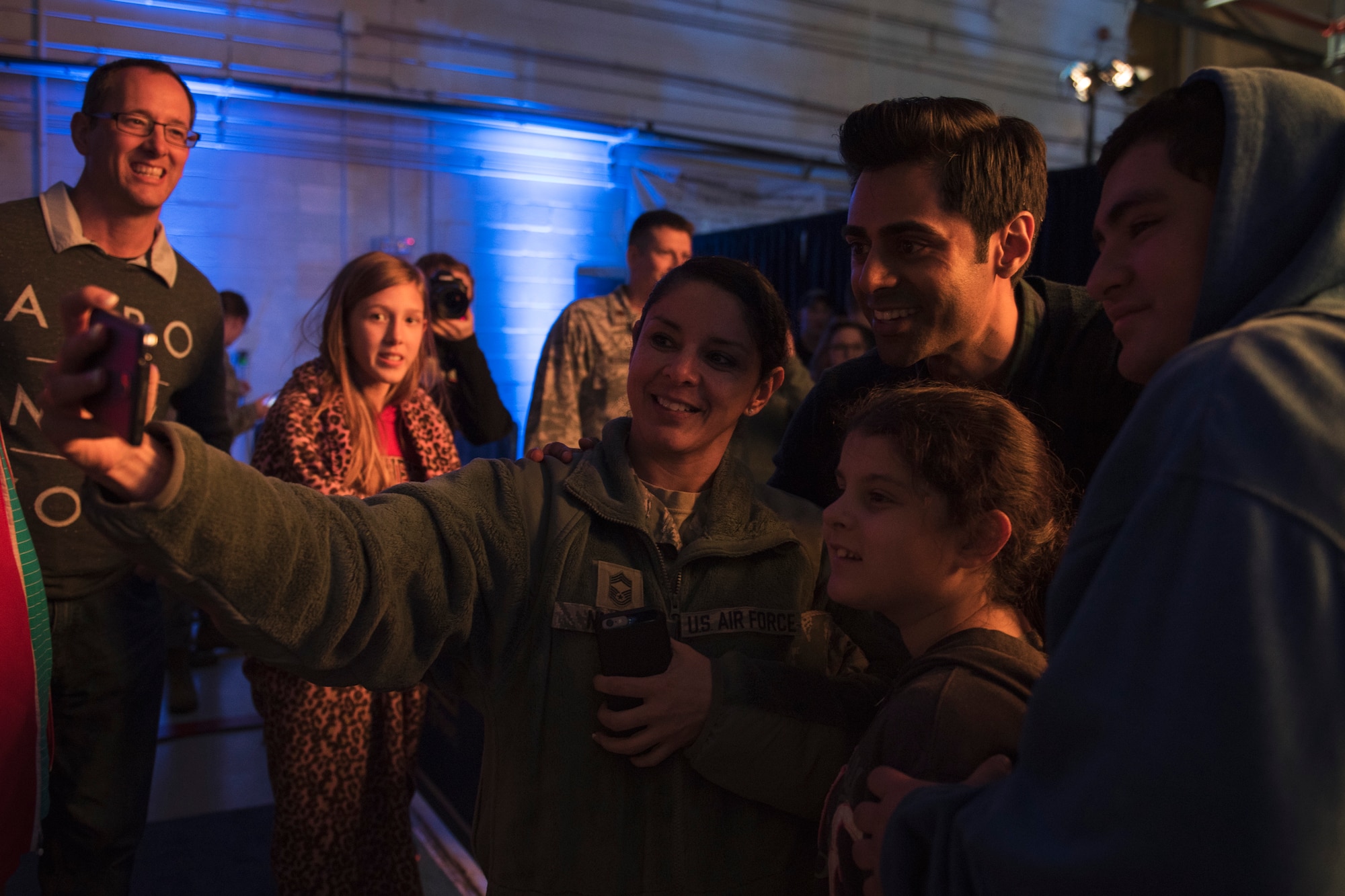 Hasan Minhaj, comedian, takes a group photo with Chief Master Sgt. Sandra Nunes, 779th Medical Group superintendent, and her family after the ‘Celebration of Service’ comedy show on Joint Base Andrews, Md., May 5, 2016. The show celebrated Military Appreciation Month, the 5th Anniversary of Joining Forces and the 75th Anniversary of the USO. Nearly 1,500 service members, veterans and their families were on hand to see performances by Judd Apatow, Mike Birbiglia, Kristen Schaal, Hasan Minhaj, John Mulaney and Jeff Ross. (U.S. Air Force photo by Airman 1st Class Philip Bryant)