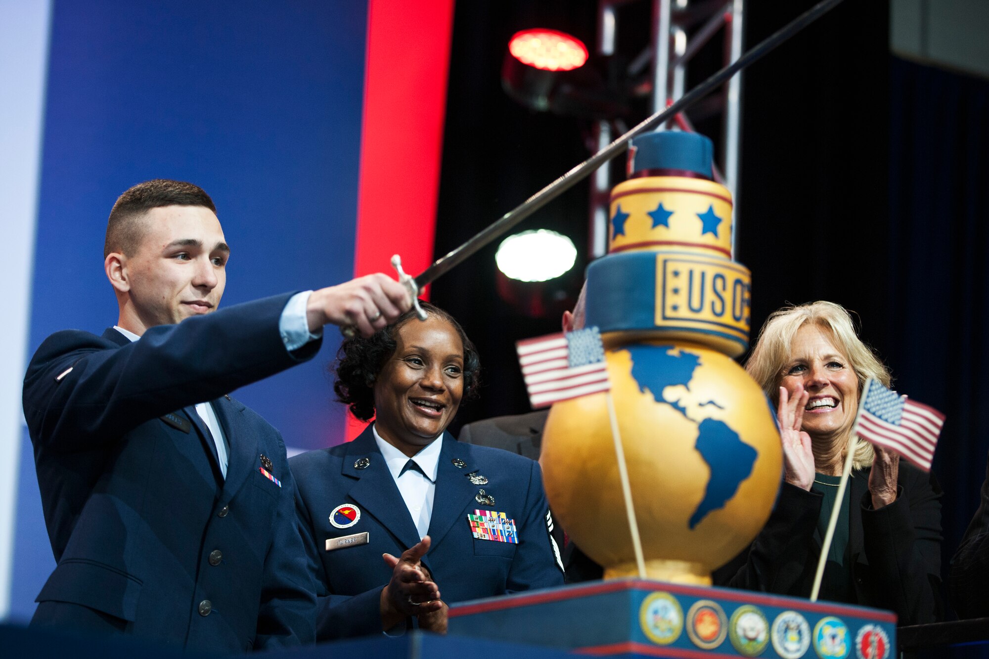 Chief Master Sgt. Kimberly Turner and Airman Cody Charles cut the ceremonial cake during the ‘Celebration of Service’ comedy show on Joint Base Andrews, Md., May 5, 2016. The show celebrated Military Appreciation Month, the 5th Anniversary of Joining Forces and the 75th Anniversary of the USO. Nearly 1,500 service members, veterans and their families were on hand to see performances by Judd Apatow, Mike Birbiglia, Kristen Schaal, Hasan Minhaj, John Mulaney and Jeff Ross. (U.S. Air Force photo by Airman 1st Class Philip Bryant)