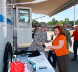 Staff Sgt. Shellie Vincent, 778th Civil Engineer Squadron Emergency Manage-ment Flight specialist, talks with Belinda Mitchell, Air Force Sustainment Center contracting emergency focal point and procurement analyst, at the PrepareAthon event, April 29 in front of the Exchange. The Robins Readiness Team provided information on how to prepare homes for emergency situations. (U.S. Air Force photo by Misuzu Allen)