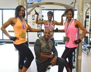 Clockwise from left, Teresa Taylor, Air Force Life Cycle Management Center contract specialist; Capt. Hope Bell, 116th Maintenance Squadron maintenance officer; Debra Ford, Supply Chain Management Squadron item manager; and Richard Williams, strength flexibility class instructor; show off the hardware their hard work helped bring home after a recent body building and fitness competition. (U.S. Air Force photo by Ray Crayton)