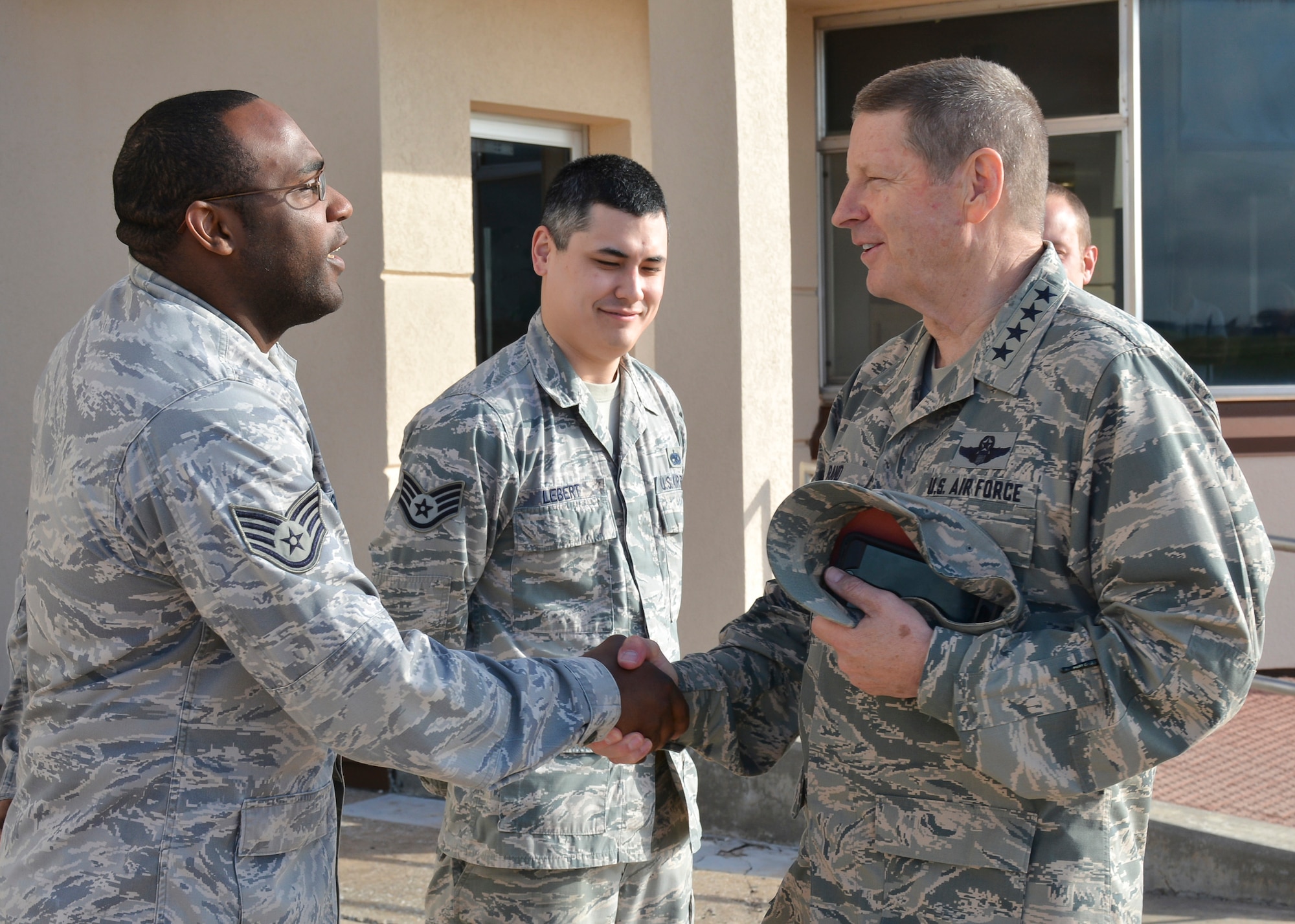 Gen. Robin Rand, commander, Air Force Global Strike Command, shakes hands with Staff Sgt. Joshua Gilreath, 76th Propulsion Maintenance Group, prior to the general’s departure from Tinker April 27. Sergeant Gilreath served as one of three primary support team members during General Rand and his wife, Kim’s, two-day visit to the base. The support detail also consisted of Staff Sgt. Roy Lebert, 545th Propulsion Maintenance Squadron, center, and Staff Sgt. Tim Coulson, 76th Aircraft Maintenance Group. (Air Force photo by Darren D. Heusel/Released)

