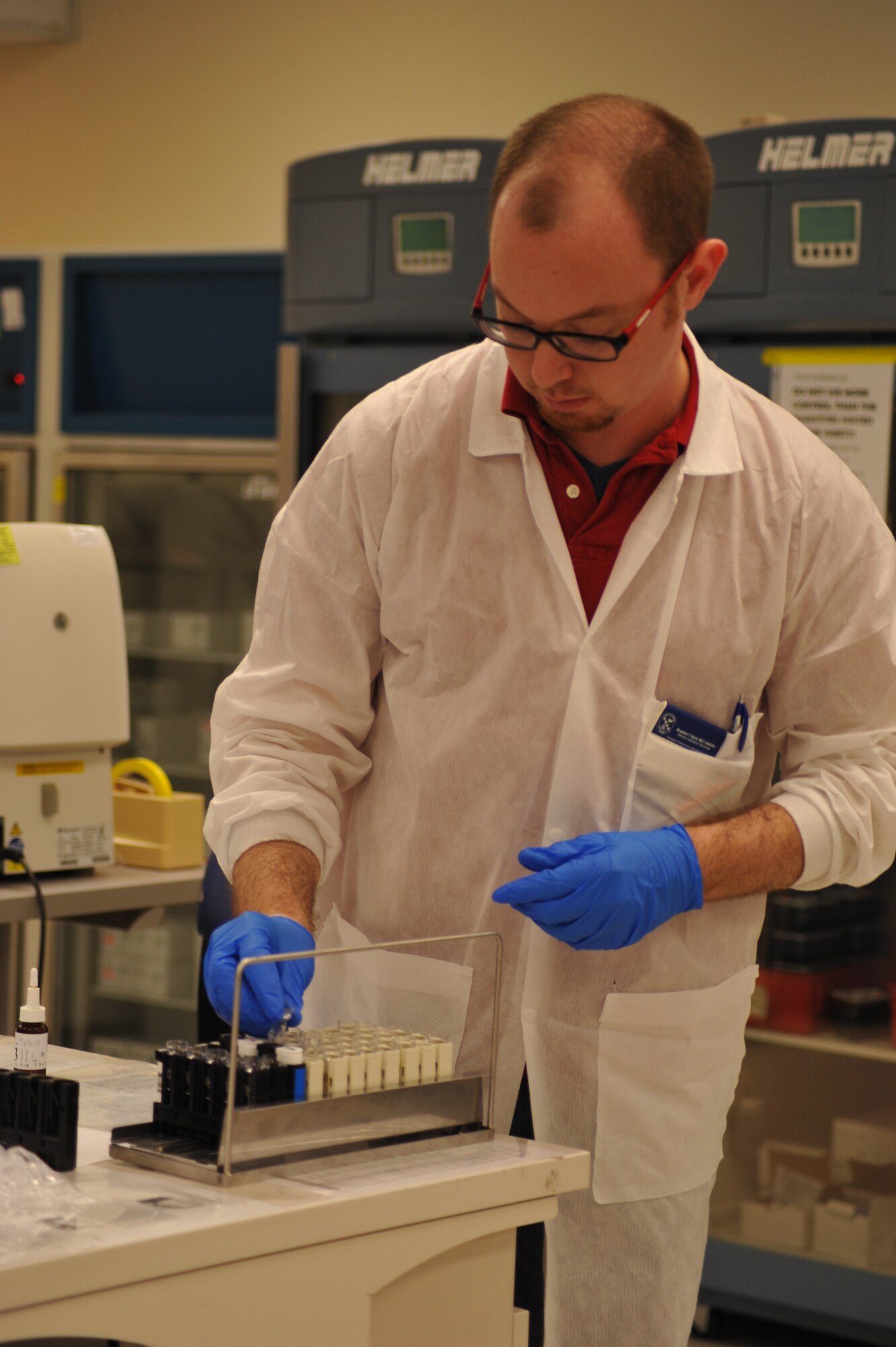Braaden Byrd, a medical laboratory technician, prepares to check the automated Complete Blood Count machine located in the Wright-Patterson Medical Center laboratory.  The machine is tested daily for accuracy. (U.S. Air Force photo/Mary H. Allen)