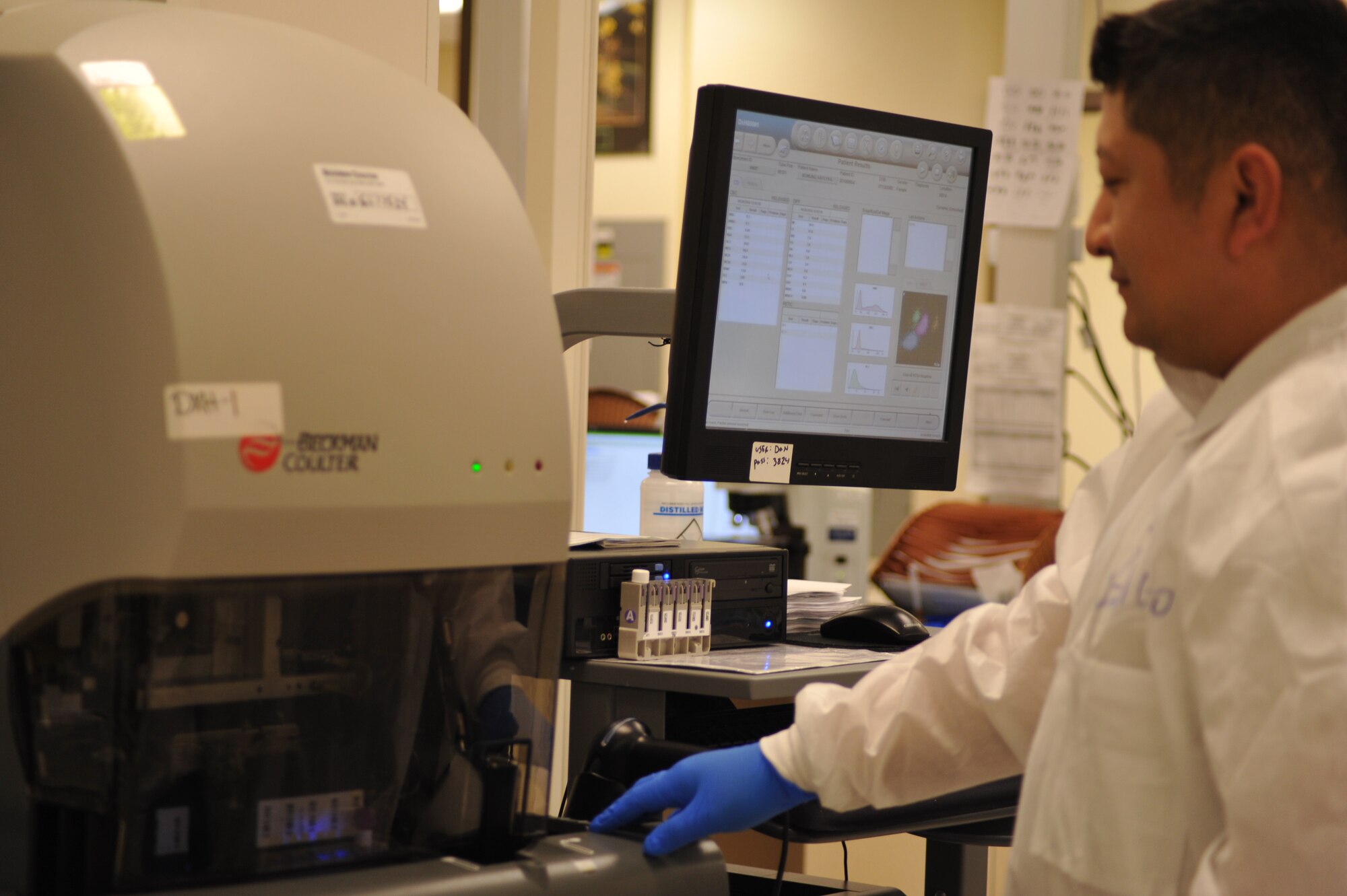 Staff Sgt. Bayardo Sobalvarro, medical laboratory scientist, places a blood specimen inside the automated Complete Blood Count machine located in the Wright-Patterson Medical Center laboratory. The Machine reads the blood cells and prints a reading for doctors to review. (U.S. Air Force photo/Mary H. Allen)
