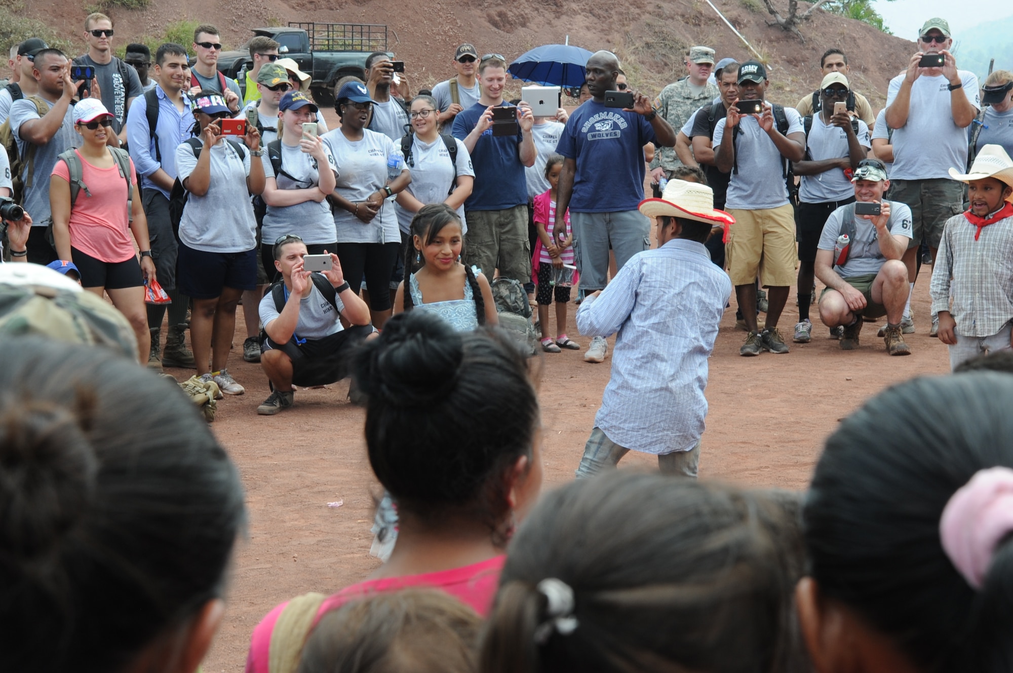 Children from the village of Montaña La Oki, located 4,406 feet above sea level in the mountains east of Comayagua, Honduras, perform a cultural dance as a way of showing their appreciation to the 158 military and civilian members of Joint Task Force-Bravo and volunteer firefighters from the local area who hiked 7.4 miles roundtrip to deliver 3,000 pounds of food to 172 families in the village during Chapel Hike 67, April 30, 2016. Chapel hikes have been occurring since 2003, with the JTF-Bravo Chapel sponsoring an average of six every year. The hikes are designed to provide a practical way for JTF-Bravo members to engage and partner with local communities to provide support to surrounding villages in need of food and supplies. (U.S. Air Force photo by Capt. David Liapis/Released)
