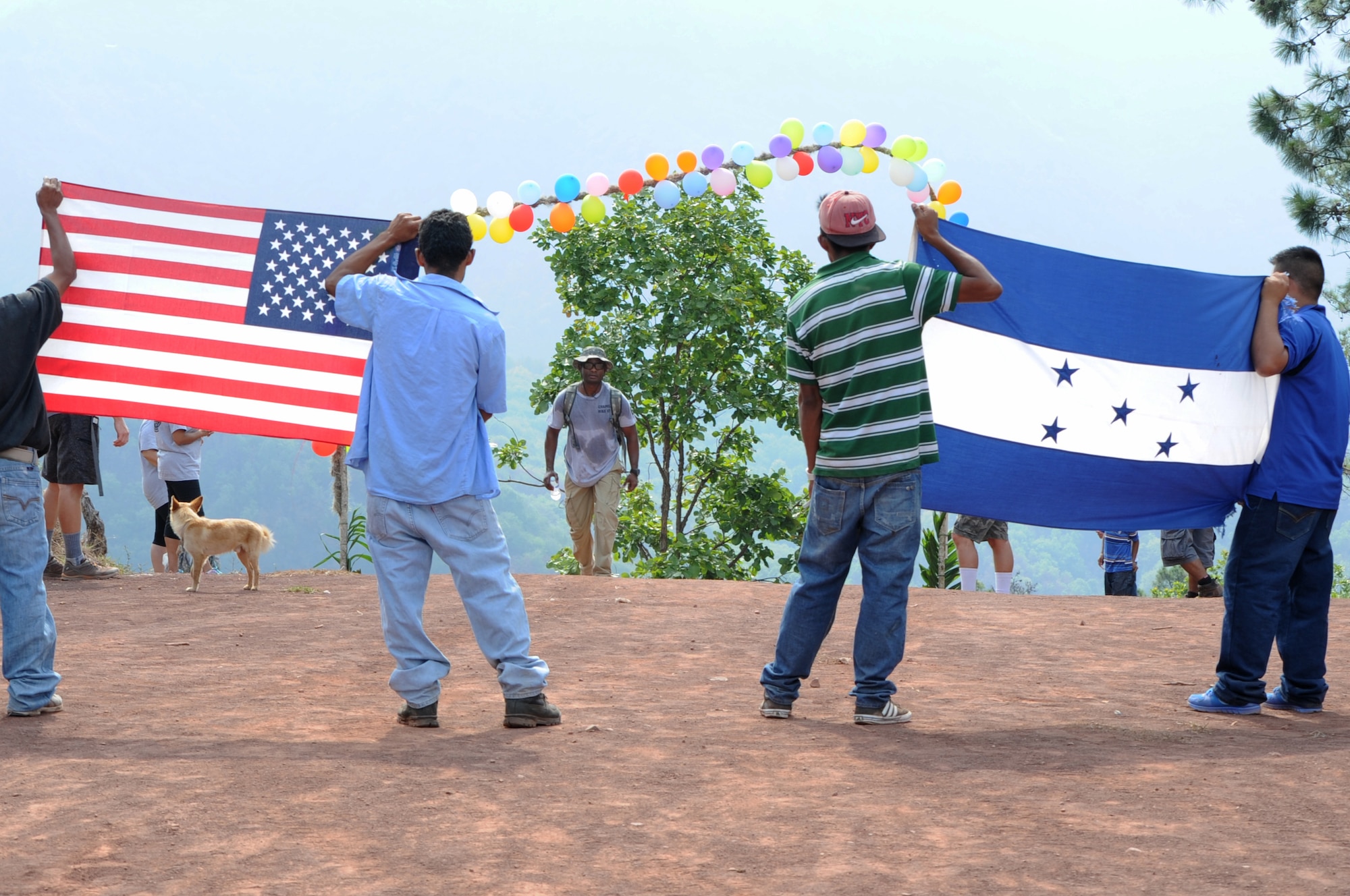 Residents of Montaña La Oki, a small village located in the mountains east of Comayagua, Honduras, welcome U.S. service members and civilians from Joint Task Force-Bravo to their village, where 172 families awaited the arrival of the participants of Chapel Hike 67 and the 3,000 pounds of food they carried 3.4 miles up the mountain April 30, 2016. In addition to the ton-and-a-half of food, which was packed into 150 bags containing 20 pounds apiece by volunteers two nights prior to the trek, many hikers brought their own additional treats and toys to give to the dozens of children they met at the top of the mountain, which was 4,406 feet above sea level. The hikes are designed to provide a practical way for JTF-Bravo members to engage and partner with local communities to provide support to surrounding villages in need of food and supplies.  (U.S. Air Force photo by Capt. David Liapis/Released)