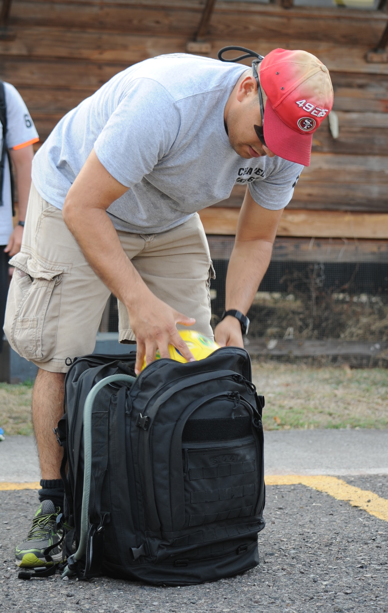 U.S. Air Force Capt. Jesus Lopez, Joint Task Force-Bravo personnel officer, fits a soccer ball into his backpack before departing for Chapel Hike 67, April 30, 2016, Soto Cano Air Base, Honduras. Lopez gave the ball to the children of Montaña La Oki, a small village located in the mountains east of Comayagua, Honduras. During the visit, U.S. service members had the opportunity to watch local school children perform cultural dances, play soccer and hand out 150 bags of food to villagers as well as some Hondurans who traveled to the location on horseback from the surrounding mountains.  (U.S. Air Force photo by Capt. David Liapis/Released)