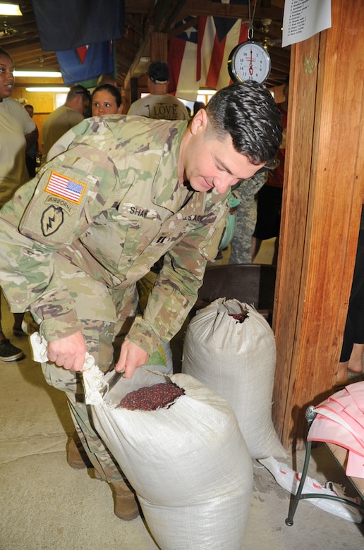 U.S. Army Capt. Matthew Shaw, Joint Task Force-Bravo operations battle captain, opens a sack of beans to be distributed into some of the 150 bags of food to be delivered to the people of Montaña La Oki, a small village located in the mountains east of Comayagua, Honduras, during the preparations for Chapel Hike 67 at the Soto Cano Air Base chapel, Honduras, April 28, 2016. Dozens of military and civilians from JTF-Bravo prepared 3,000 pounds of food to be taken to the village, contributing to the JTF’s mission objective of building partnership capacity with the Hondurans, as well as providing an opportunity for service members to show compassion and kindness to others who are in need. (U.S. Air Force photo by Capt. David Liapis/Released)