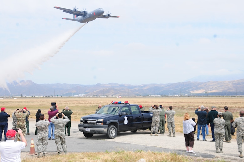 California Air National Guard's C-130J drops water near onlookers during MAFFS annual certification and training at the 146th Airlift Wing in Port Hueneme, California on May 4, 2016. Air National Guard and Reserve units from across the U.S. convened for MAFFS (Modular Airborne Fire Fighting Systems)annual certification and training this week to prepare for the upcoming fire season in support of U.S. Forest Service. (U.S. Air National Guard photo by Senior Airman Madeleine Richards/Released)
