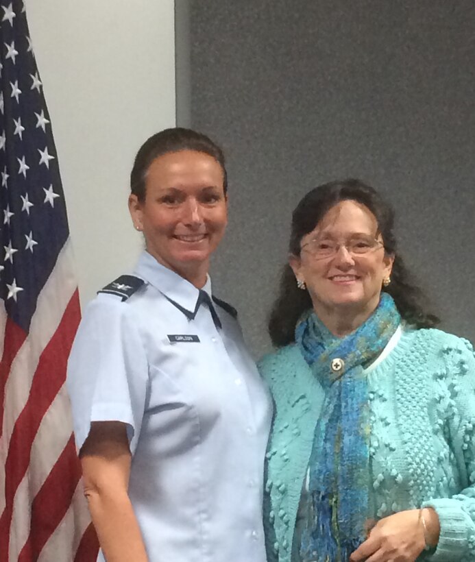 Colonel Kristin Carlson, 779th Medical Group chief nurse congratulates Suzanne Bucci, a volunteer nurse with the Red Cross for 34 years. Bucci has accumulated over 40,000 volunteer hours with the 779th Medical Group on Joint Base Andrews. She volunteers in the Acupuncture and Integrative Medicine (AIM) Center.