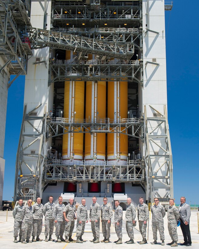 Members of the 45th Launch Group, wing staff and ULA pose in front of the United Launch Alliance Delta IV heavy rocket on Space Launch Complex 37 at Cape Canaveral Air Force Station May 5, 2016. Lt. Gen. David J. Buck, commander, 14th Air Force (Air Forces Strategic), Air Force Space Command; and commander, Joint Functional Component Command for Space, U.S. Strategic Command, and Chief Master Sgt. Craig Neri, 14th AF command chief and command senior enlisted leader for JFCC Space, visited Patrick Air Force Base and Cape Canaveral Air Force Station May 4 and 5 and gained insight into the contributions Airmen across the wing make to keep the 45th Space Wing the World's Premier Gateway to Space. (U.S. Air Force photo by Matthew Jurgens/Released)