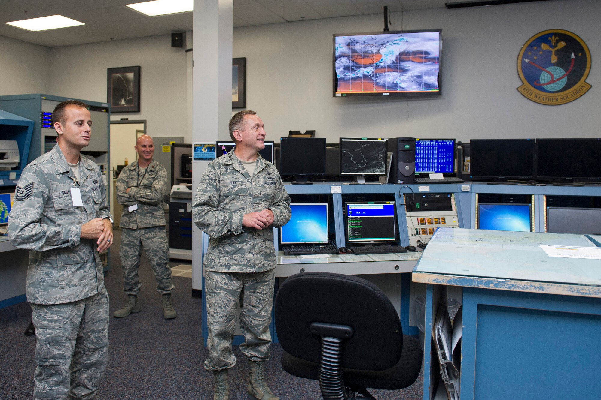 Tech. Sgt. Jordan Smith and Maj. Jeffrey Smith, both from the 45th Weather Squadron, tell Lt. Gen. David J. Buck, commander, 14th Air Force (Air Forces Strategic), Air Force Space Command; and commander, Joint Functional Component Command for Space, U.S. Strategic Command, about the 45th WS and how they support launch operations while he tours the Morrell Operations Center at Cape Canaveral Air Force Station, Florida, May 5, 2016. Buck and Chief Master Sgt. Craig Neri, 14th AF command chief and command senior enlisted leader for JFCC Space, visited Patrick Air Force Base and Cape Canaveral Air Force Station May 4 and 5 and gained insight into the contributions Airmen across the wing make to keep the 45th Space Wing the World's Premier Gateway to Space. (U.S. Air Force photo by Matthew Jurgens/Released)