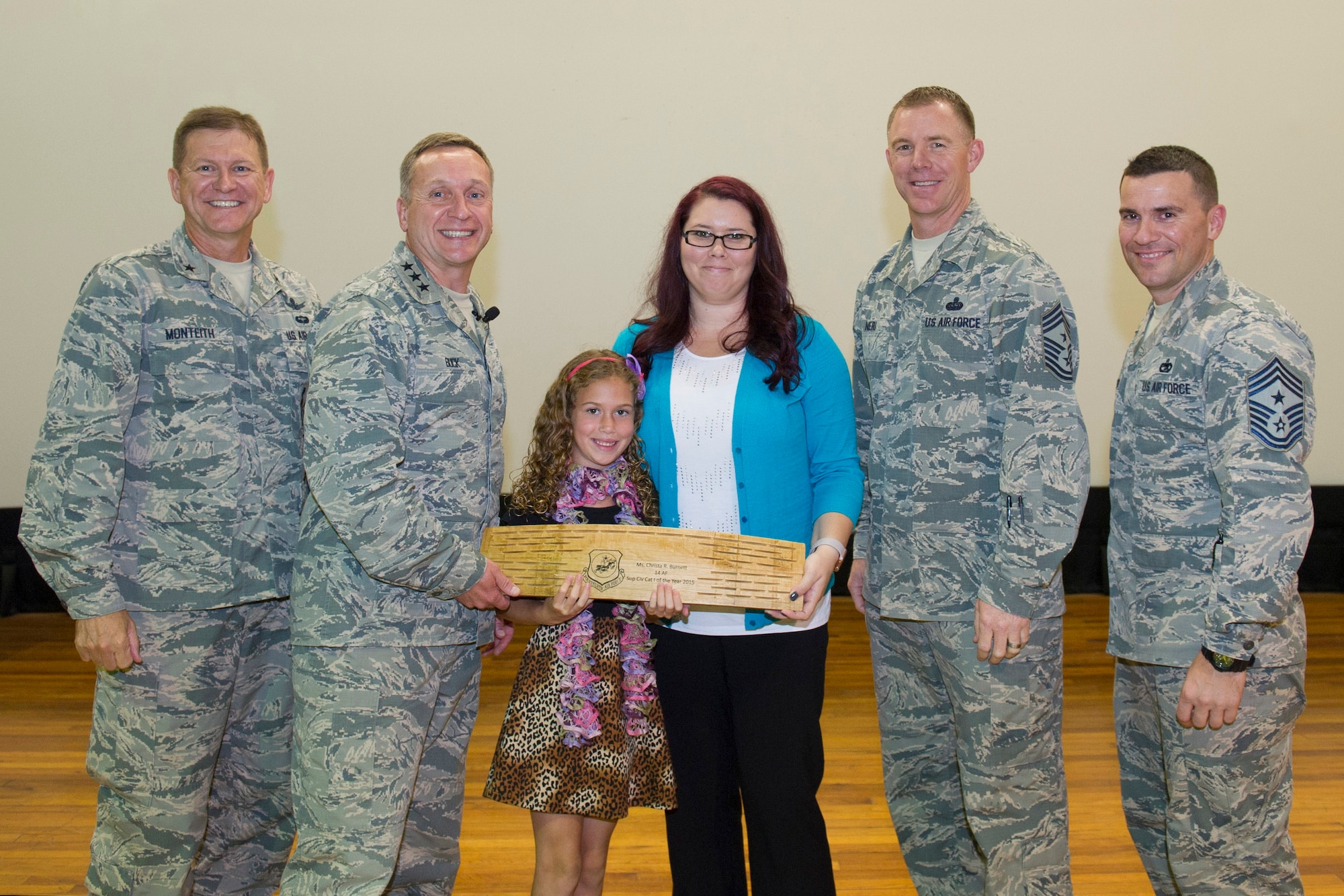 Christa R. Burnet, 45th Force Support Squadron, is presented the 14th Air Force Civilian of the Year, Category I, Supervisor, at an all call hosted by the 14th Air Force commander and command chief May 4, 2016, at Patrick Air Force Base, Florida. During the all call, Lt. Gen. David J. Buck, commander, 14th Air Force (Air Forces Strategic), Air Force Space Command; and commander, Joint Functional Component Command for Space, U.S. Strategic Command, and Chief Master Sgt. Craig Neri, 14th AF command chief and command senior enlisted leader for JFCC Space, touched on what it takes to be a good Airman and presented several awards. (U.S. Air Force photo by Matthew Jurgens/Released)