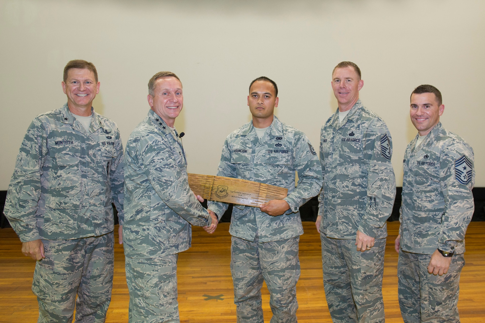 Tech. Sgt. Michael Asuncion, Jr., 45th Civil Engineer Squadron, is presented the 14th Air Force Non-commissioned officer of the Year Award for 2015 at an all call hosted by the 14th Air Force commander and command chief May 4, 2016, at Patrick Air Force Base, Florida. During the all call, Lt. Gen. David J. Buck, commander, 14th Air Force (Air Forces Strategic), Air Force Space Command; and commander, Joint Functional Component Command for Space, U.S. Strategic Command, and Chief Master Sgt. Craig Neri, 14th AF command chief and command senior enlisted leader for JFCC Space, touched on what it takes to be a good Airman and presented several awards. (U.S. Air Force photo by Matthew Jurgens/Released)