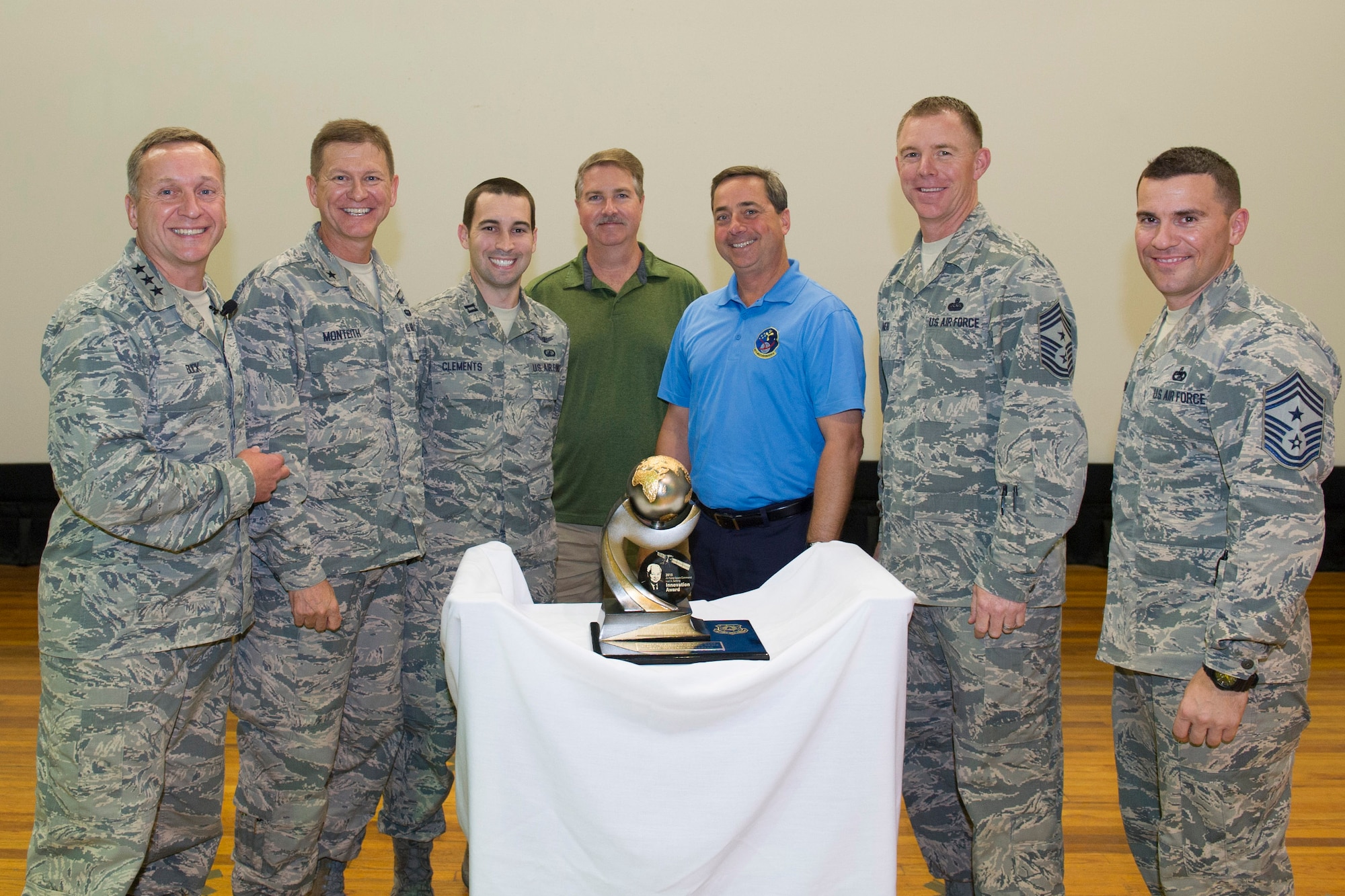 Capt. Kyle Clements, 5th Space Launch Squadron, left of center, Bradley Andrew, NASA Kennedy Space Center, center, and Mike McAleenan, 45th Weather Squadron, right of center, are presented the Air Force Space Command Ivan A. Getting Innovation Award for 2015 during an all call hosted by the 14th Air Force commander and command chief at Patrick Air Force Base, Florida, May 4, 2016. The award recognizes the year’s most innovative contribution to the Air Force Space Command mission and is named after Dr. Ivan A. Getting, a space pioneer recognized in the Space and Missile Hall of Fame for his creative work in navigational technology and vital work in the development of GPS. (U.S. Air Force photo by Matthew Jurgens/Released)