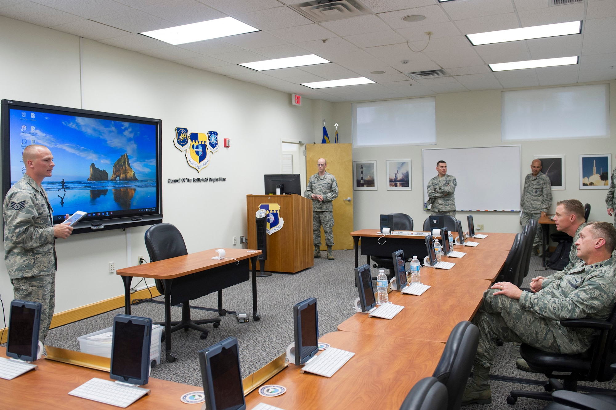 Airmen leadership school instructors describe how they’ve innovated using iPads in their course material to Lt. Gen. David J. Buck, commander, 14th Air Force (Air Forces Strategic), Air Force Space Command; and commander, Joint Functional Component Command for Space, U.S. Strategic Command, and Chief Master Sgt. Craig Neri, 14th AF command chief and command senior enlisted leader for JFCC Space, at the Patrick Air Force Base Professional Development Center May 4, 2016. Buck and Neri visited Patrick Air Force Base and Cape Canaveral Air Force Station May 4 and 5 and gained insight into the contributions Airmen across the wing make to keep the 45th Space Wing the World's Premier Gateway to Space. (U.S. Air Force photo by Matthew Jurgens/Released)