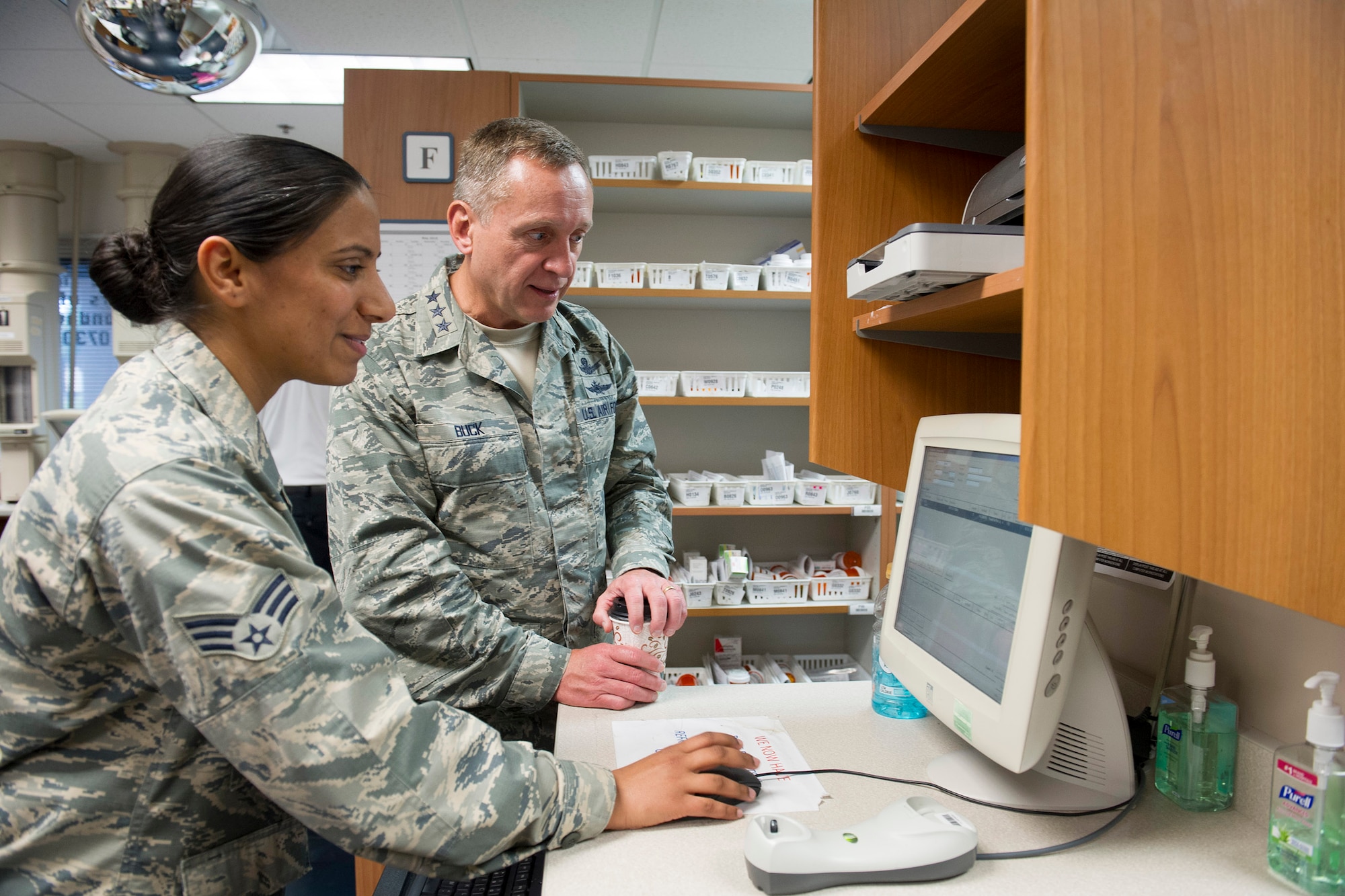 Senior Airman Kulwinder McDaniel, 45th Medical Group, shows Lt. Gen. David J. Buck, commander, 14th Air Force (Air Forces Strategic), Air Force Space Command; and commander, Joint Functional Component Command for Space, U.S. Strategic Command, the process used to manage and distribute prescriptions at the Satellite Pharmacy on Patrick Air Force Base, Florida, May 4, 2016. Buck and Chief Master Sgt. Craig Neri, 14th AF command chief and command senior enlisted leader for JFCC Space, visited Patrick Air Force Base and Cape Canaveral Air Force Station May 4 and 5 and gained insight into the contributions Airmen across the wing make to keep the 45th Space Wing the World's Premier Gateway to Space. (U.S. Air Force photo by Matthew Jurgens/Released)