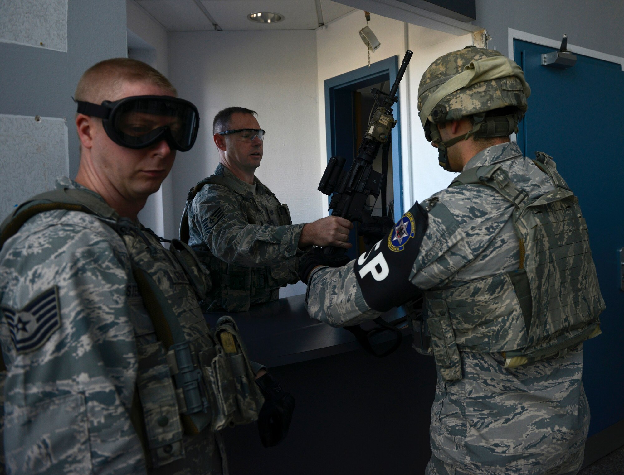 Christian Smith, 569th USFPS assistant NCO in charge of training, issues out training weapons for active-shooter training at Vogelweh Military Complex, Germany, May 5, 2016. The simulated active shoot and Airmen responding to the threat were issued weapons that shot simulation rounds, making the training as realistic as possible. (U.S. Air Force photo/ Airman 1st Class Joshua Magbanua)