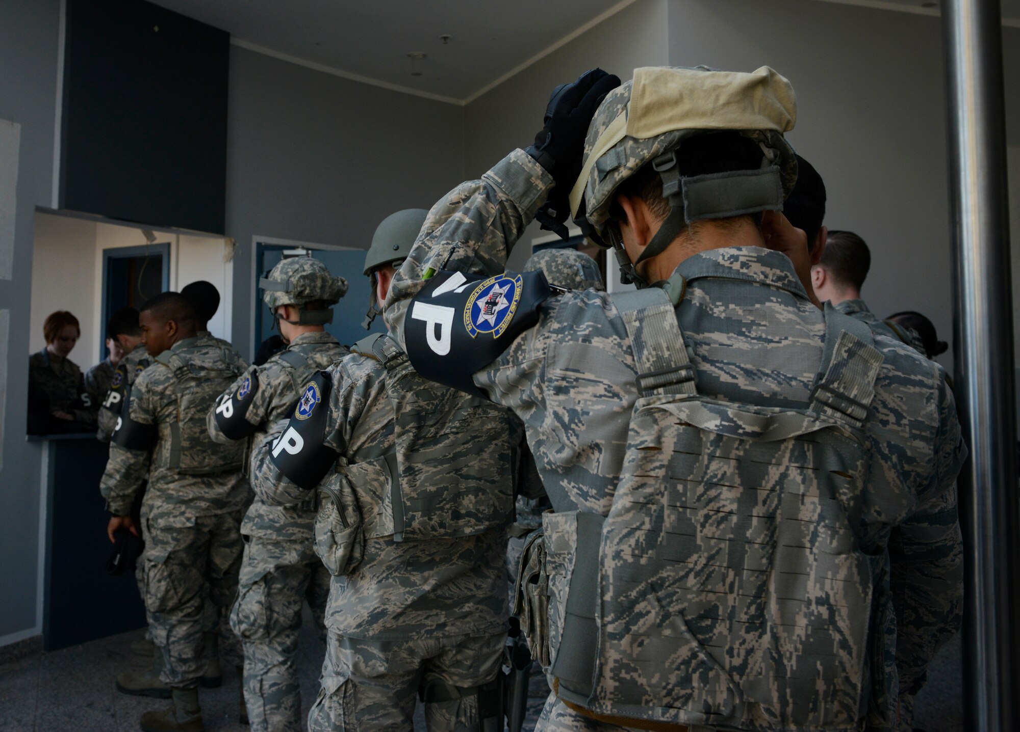 Members of the 569th U.S. Forces Police Squadron line up to receive their weapon prior to participating in active-shooter training at Vogelweh Military Complex, Germany, May 5, 2016. For realistic training the Airmen were issued weapons that shot simulation rounds. (U.S. Air Force photo/ Airman 1st Class Joshua Magbanua)