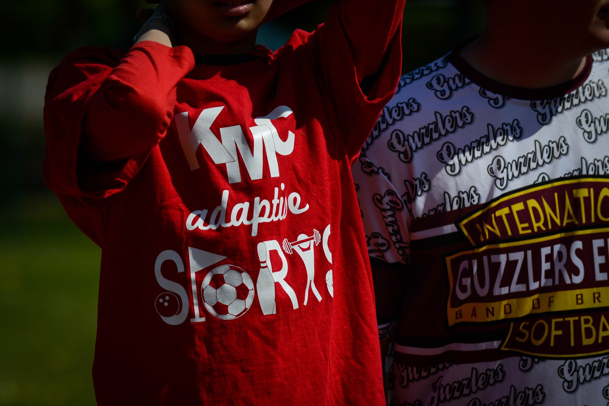 A Kaiserslautern Middle School student wears a Kaiserslautern Military Community adaptive sports shirt May 2, 2016, at Ramstein Air Base, Germany.  The student was one of more than 20 special needs kids who participated in a softball game between Kaiserslautern and Ramstein middle and high schools. (U.S. Air Force photo/Senior Airman Nicole Keim)