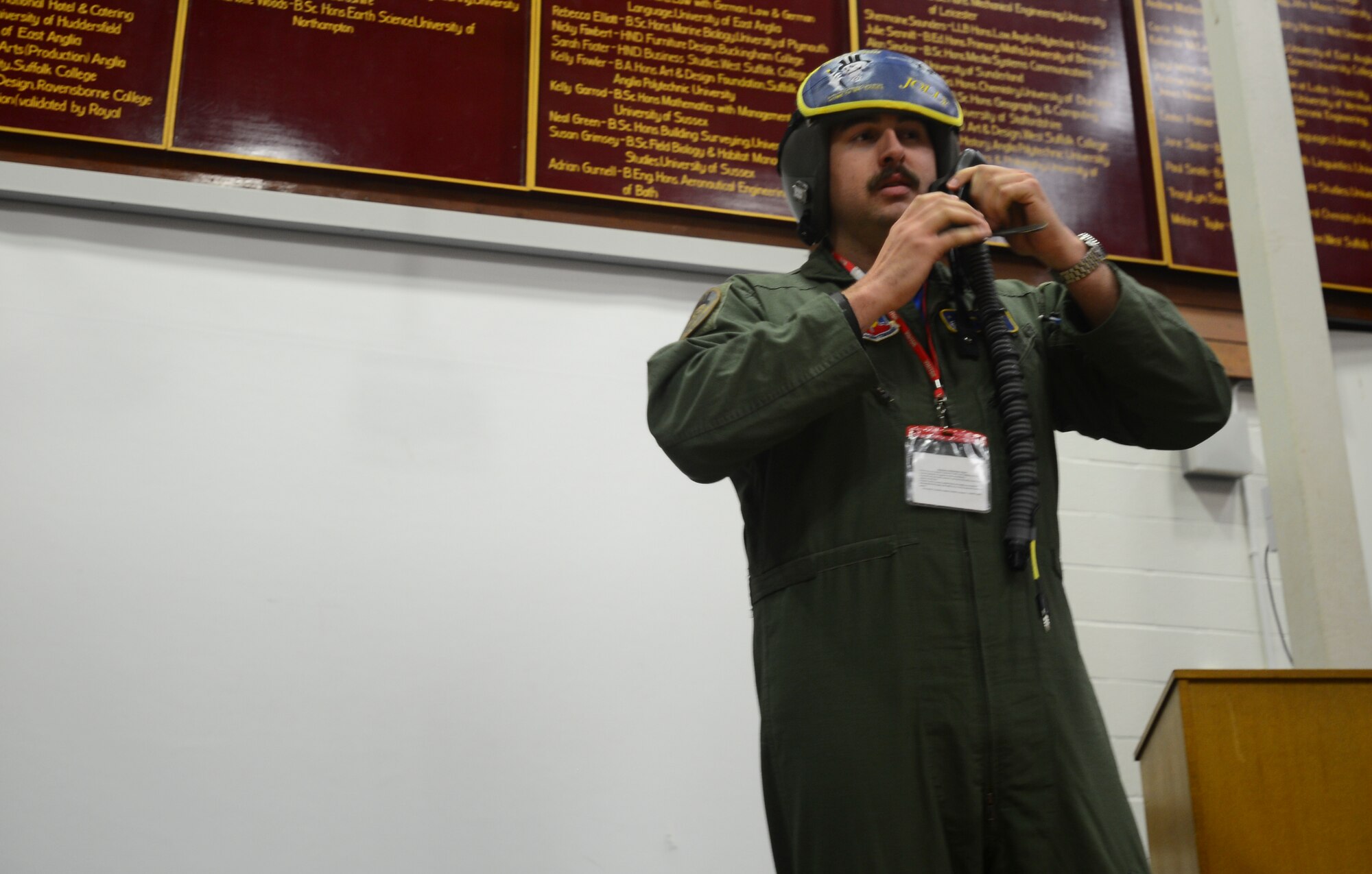 1st Lt. “Jolly” Foss, 95th Fighter Squadron F-22 Raptor pilot, explains the different capabilities of an F-22 Raptor pilot’s helmet during an assembly at Mildenhall College Academy, England, May 6, 2016. During their time in the U.K., the Airmen engaged with the local community to educate them about the U.S. Air Force mission, as well as the importance of training with host nation allies. (U.S. Air Force photo by Senior Airman Dawn M. Weber/Released)