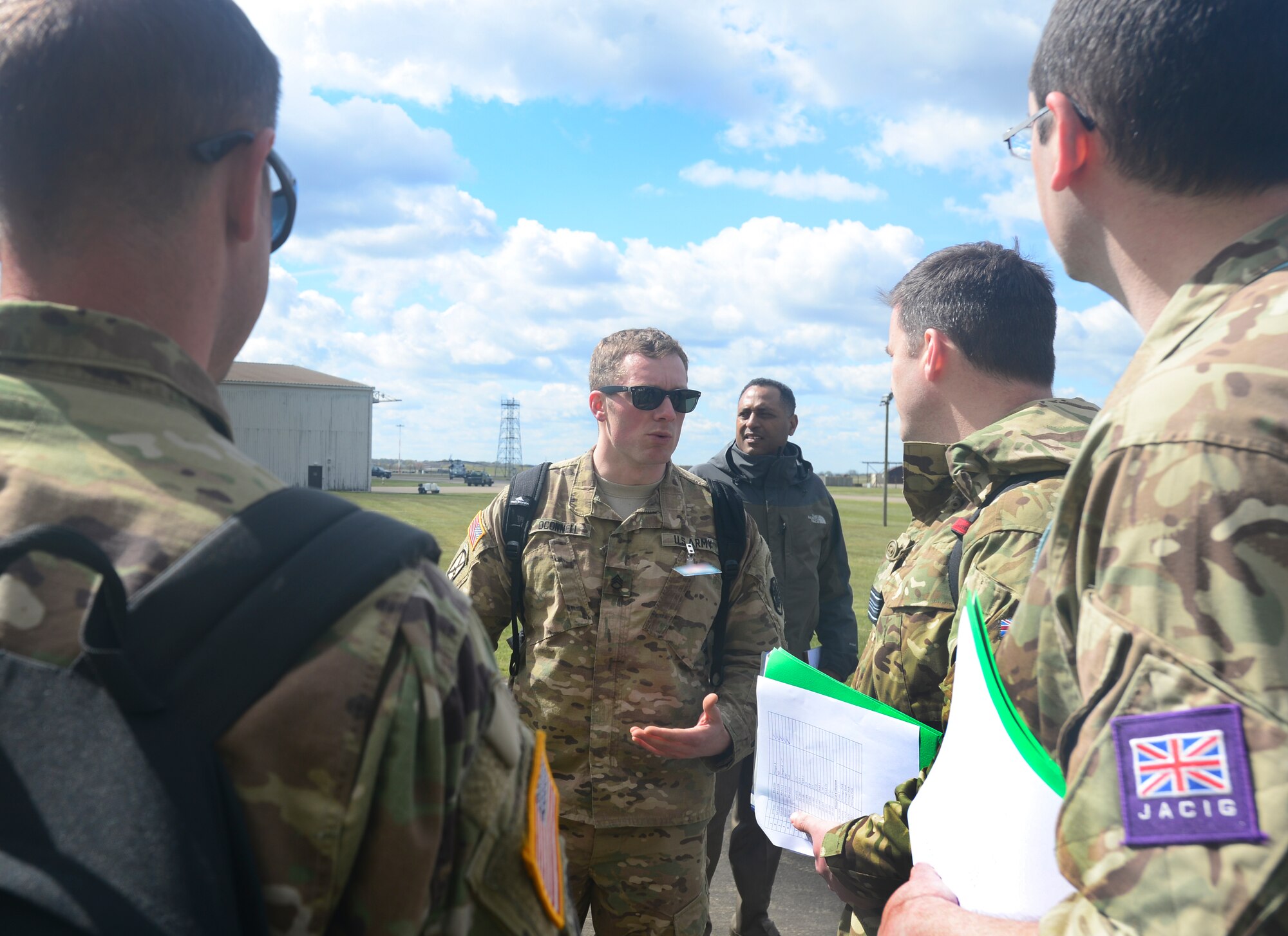 U.S. Army Staff Sgt. Taylor O’Connell, Defense Threat Reduction Agency-On Site Europe noncommissioned officer in charge of the CFE exercise inspection, briefs the inspectors before entering Hangar 8 at Royal Air Force Lakenheath, England, April 28, 2016. The CFE treaty promotes military transparency and communication amongst signatory countries, which serves to prevent uncertainties regarding other states actions and creates a more cooperative security situation for all parties. (U.S. Air Force photo by Senior Airman Dawn M. Weber/Released)