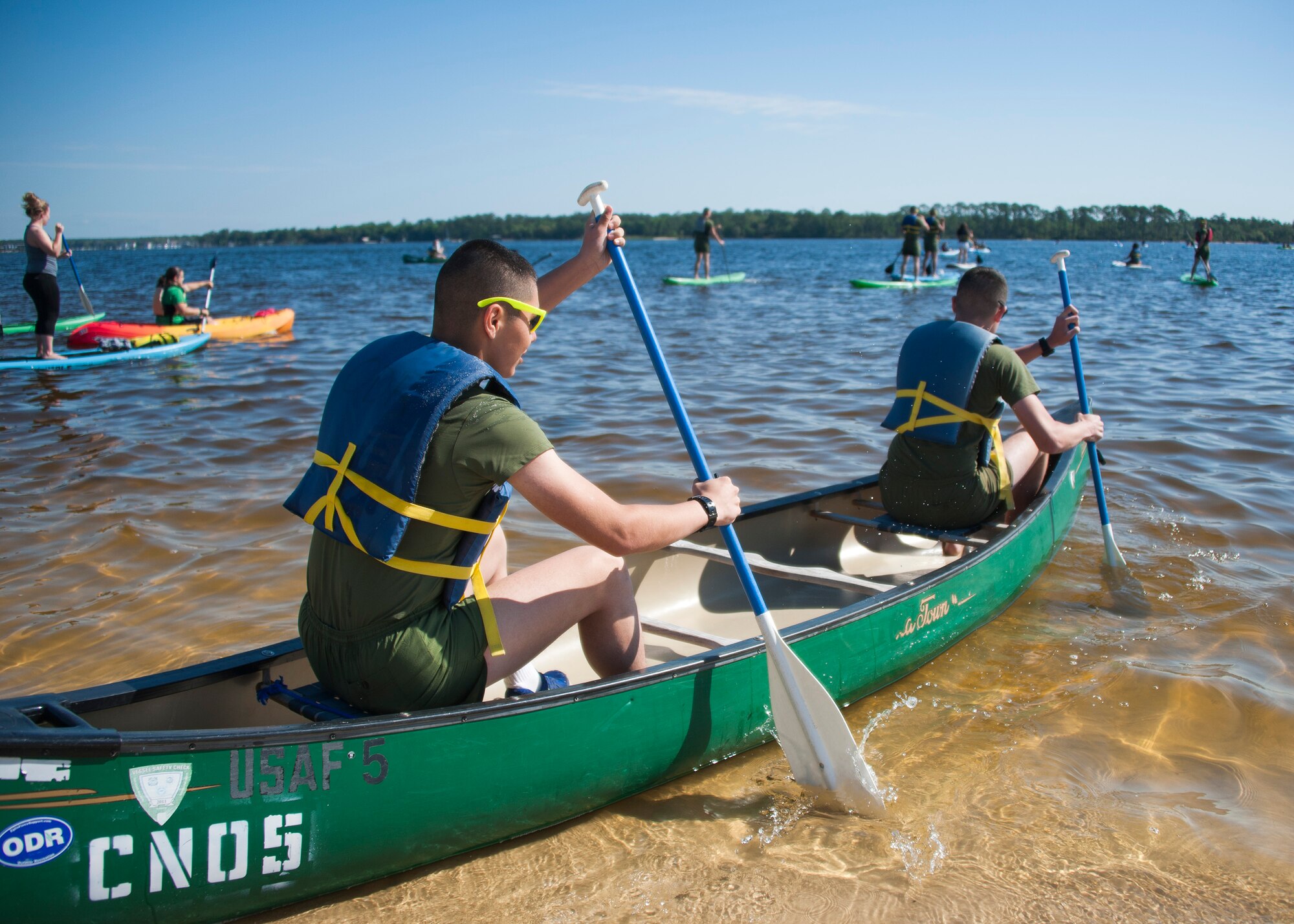 Team Eglin Marines sit in a canoe ready to paddle during the 96th Force Support Squadron’s Mission Breakfast May 4 at Eglin Air Force Base, Fla. The 96th FSS’s Outdoor Recreation provided free boat and equipment rentals for the day. (U.S. Air Force photo/Ilka Cole) 