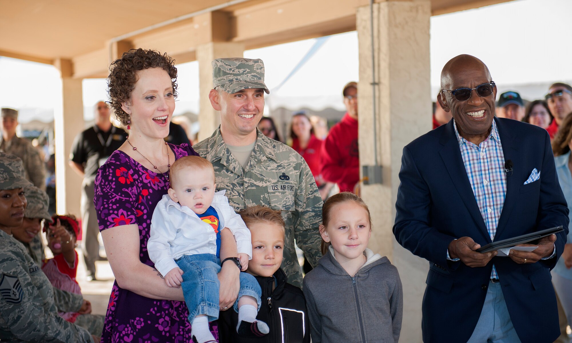 Sarah Whitney, gasps and smiles as she watches a video surprise from her husband, Master Sgt. Michael Whitney, 53rd Wing, and the Today Show’s weatherman, Al Roker, during the 96th Force Support Squadron’s Mission Breakfast May 4 at Eglin Air Force Base, Fla.  Whitney was diagnosed with Stage 3 breast cancer during her pregnancy with her son, Kal-El, named after Superman. (U.S. Air Force photo/Ilka Cole)