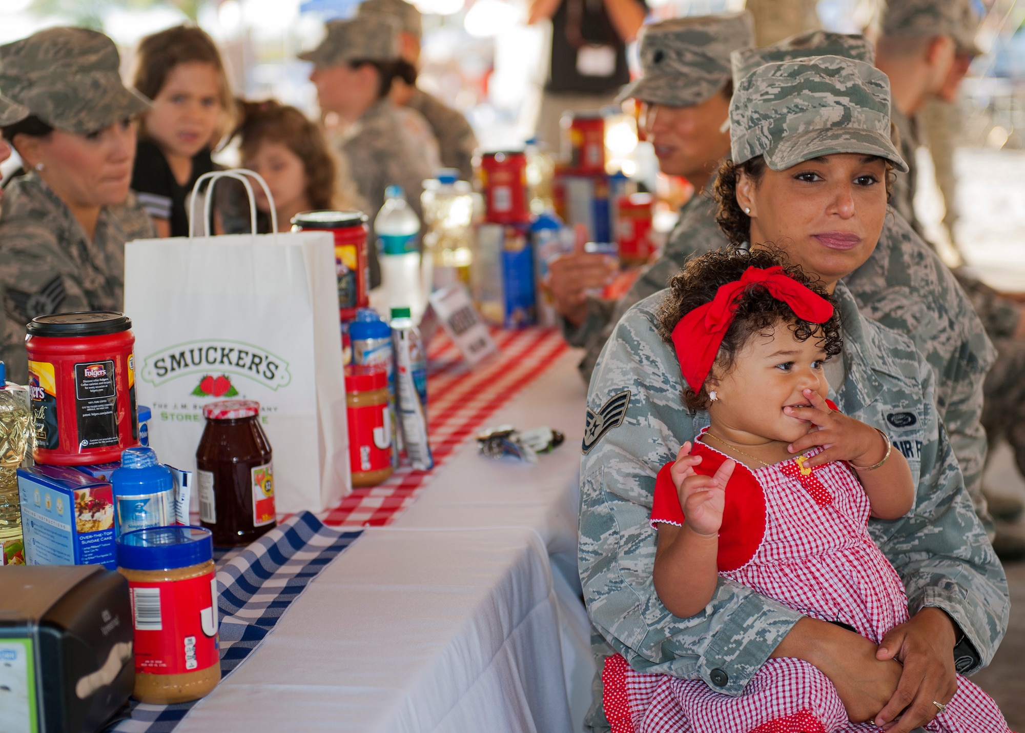 Staff Sgt. Erica Veras, 53rd Wing, holds her daughter close during the 96th Force Support Squadron’s Mission Breakfast May 4 at Eglin Air Force Base, Fla. The Eglin commissary won a photo contest that awarded free breakfast to all Eglin members.  (U.S. Air Force photo/Ilka Cole)