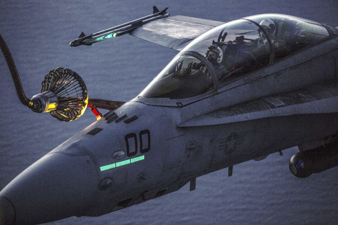 Marines refuel in the air over Iwakuni, Japan, April 28, 2016, practicing during the day and night to prepare for any scenario. The Marines are assigned to Marine Aerial Refueler Transport Squadron 152 and Marine All-Weather Fighter Attack Squadron 242. Marine Corps photo by Cpl. Nathan Wicks