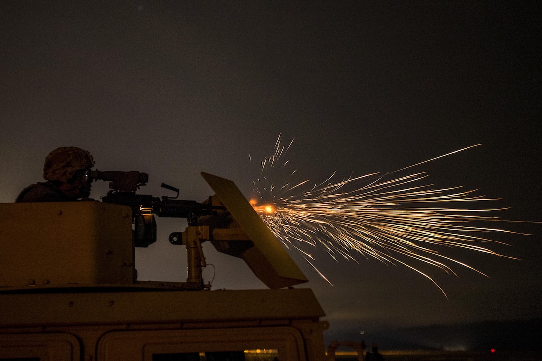 An Army Reserve soldier fires an M249 automatic weapon mounted on a high-mobility vehicle turret at Fort Hunter-Liggett, Calif., May 4. The soldier is assigned to the 341st Military Police Company. Army photo by Master Sgt. Michel Sauret