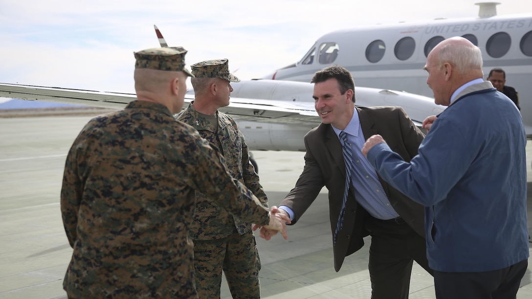 Col. Jay Wylie, assistant chief of staff, G-4 Installations and Logistics, and Maj Gen. Lewis A. Craparotta, Combat Center Commanding General, greet Mr. Joseph Bryan, Deputy Assistant Secretary of the Navy, and the Honorable Dennis V. McGinn, Assistant Secretary of the Navy at the Strategic Expeditionary Landing Field, Jan. 21, 2016. McGinn later awarded the Combat Center’s Exercise Support Division the 2015 Secretary of the Navy Energy and Water Management Award in the United States Marine Corps Expeditionary category, at Lance Cpl. Torrey L. Gray Field. McGinn also recognized the Combat Center as an installation, for a Gold Level of Achievement under the awards program, which indicates a very good to outstanding energy or water program.