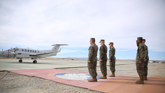 Combat Center leadership salutes the Honorable Dennis V. McGinn, Assistant Secretary of the Navy and Mr. Joseph Bryan, Deputy Assistant Secretary of the Navy, as they land at the Strategic Expeditionary Landing Field, Jan. 21, 2016. McGinn later awarded the Combat Center’s Exercise Support Division the 2015 Secretary of the Navy Energy and Water Management Award in the United States Marine Corps Expeditionary category. McGinn also recognized the Combat Center as an installation, for a Gold Level of Achievement under the awards program, which indicates a very good to outstanding energy or water program. 