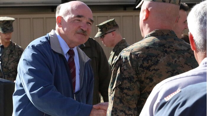 The Honorable Dennis V. McGinn, Assistant Secretary of the Navy, thanks members of Exercise Support Division after presenting the unit with the 2015 Secretary of the Navy Energy and Water Management Award in the United States Marine Corps Expeditionary category. McGinn also recognized the Combat Center as an installation, for a Gold Level of Achievement under the awards program, which indicates a very good to outstanding energy or water program.