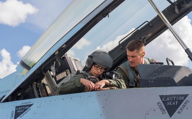 U.S. Air Force Maj. Michael Kuzmuk, an 18th Aggressor Squadron pilot, secures Airman 1st Class Victoria Ortaleza, a 354th Aircraft Maintenance Squadron electronic and environmental systems journeyman, into to the F-16D Fighting Falcon aircraft they will fly in at Eielson Air Force base, Alaska, May 4, 2016 during a RED FLAG-Alaska (RF-A) 16-1 sortie. In addition to her contributions to RF-A, Ortaleza contributed to more than 500 “Red Air” sorties in the past six months during temporary duty operations across the globe. (U.S. Air Force photo by Staff Sgt. Shawn Nickel/Released)