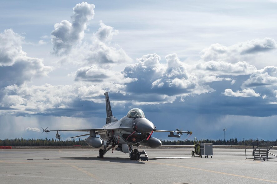 A U.S. Air Force F-16 Fighting Falcon aircraft sits on the tarmac during RED FLAG-Alaska (RF-A) 16-1 at Eielson Air Force Base, Alaska. Maintainers will keep the 18th Aggressor Squadron jets ready for more than 500 flying hours during RF-A; a Pacific Air Forces command directed field training exercise for U.S. and allied forces, to provide joint offensive counter-air, interdiction, close air support and large force employment training in a simulated combat environment. (U.S. Air Force photo by Staff Sgt. Shawn Nickel/Released)