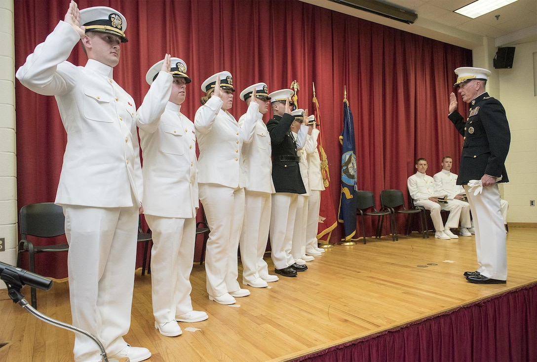 Marine Corps Gen. Joe Dunford, chairman of the Joint Chiefs of Staff, administers the oath of office to the Maine Maritime Academy Naval Reserve Officer Training Corps graduating midshipmen during a commissioning ceremony at Alexander Field House in Castine, Maine, May 7, 2016. Nine Navy ensigns and one Marine Corps 2nd Lt. were commissioned. DoD photo by Navy Petty Officer 2nd Class Dominique A. Pineiro