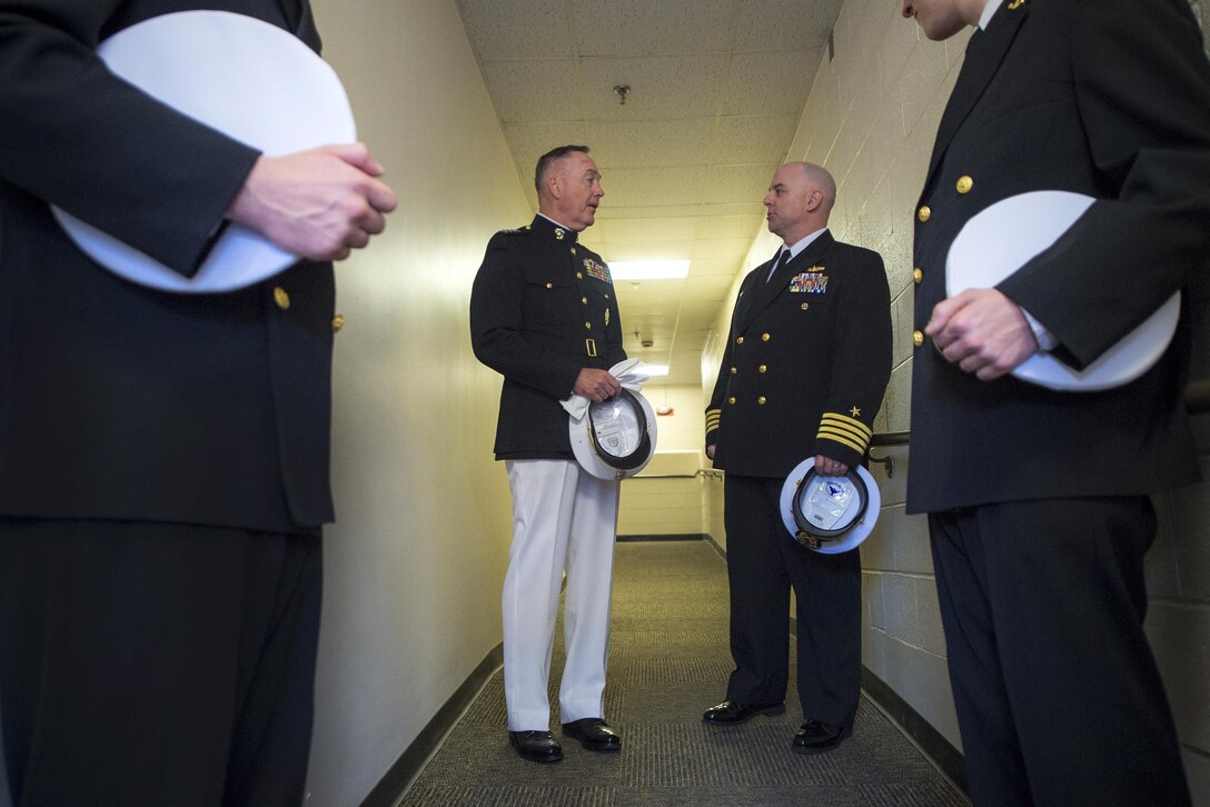 Marine Corps Gen. Joe Dunford, chairman of the Joint Chiefs of Staff, speaks to Navy Capt. Tim Cooper, commander of the Maine Maritime Academy Naval ROTC, before an oath of office commissioning ceremony at Alexander Field House in Castine, Maine, May 7, 2016. DoD photo by Navy Petty Officer 2nd Class Dominique A. Pineiro