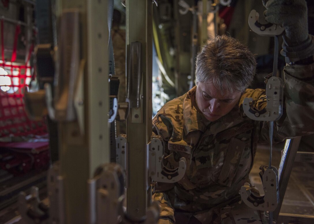 Lt. Col. Karey Dufour, 455th Expeditionary Aeromedical Evacuation Squadron, ensures that the clamps for medical stretchers are in place on a C-130J Super Hercules at Bagram Airfield, Afghanistan, May 05, 2016. If Service members must be moved from the battlefield to a medical facility outside of Afghanistan, the airmen assigned to the 455th EAES will be the link between them getting from the combat zone to higher-level medical care. (U.S. Air Force photo by Senior Airman Justyn M. Freeman)