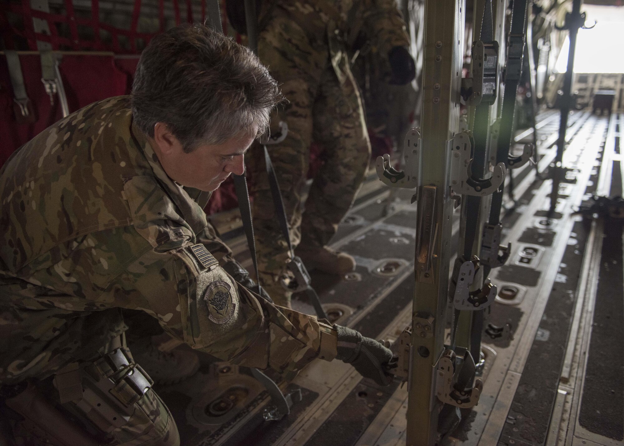 Lt. Col. Karey Dufour, 455th Expeditionary Aeromedical Evacuation Squadron, ensures that clamps for medical stretchers are in place upon a C-130J Super Hercules at Bagram Airfield, Afghanistan, May 05, 2016. Members of the 455th EAES routinely move critically ill service members after they’ve been stabilized or received damage-control surgery. (U.S. Air Force photo by Senior Airman Justyn M. Freeman)