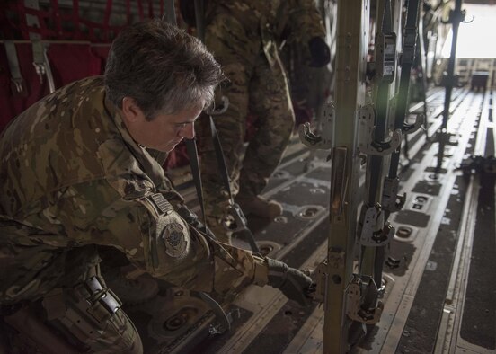 Lt. Col. Karey Dufour, 455th Expeditionary Aeromedical Evacuation Squadron, ensures that clamps for medical stretchers are in place upon a C-130J Super Hercules at Bagram Airfield, Afghanistan, May 05, 2016. Members of the 455th EAES routinely move critically ill service members after they’ve been stabilized or received damage-control surgery. (U.S. Air Force photo by Senior Airman Justyn M. Freeman)